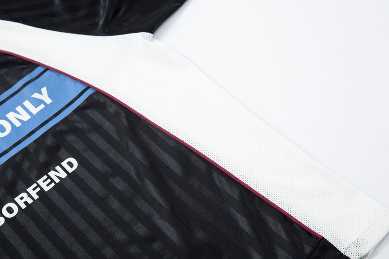 Close-up of jersey front hem area with blue CHILL VIBES ONLY band and white mesh panel