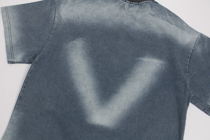 Washed blue vintage graphic T-shirt with faded spray-dye effect and relaxed streetwear fit
