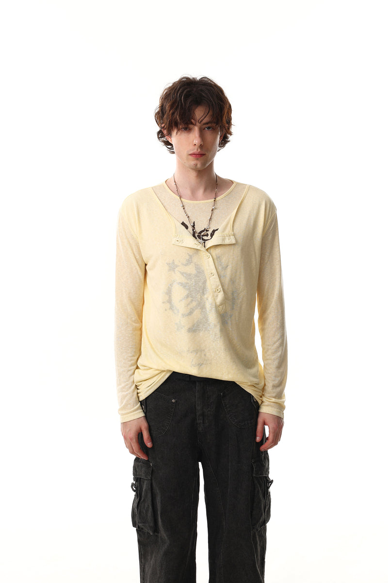 Model wearing light yellow graphic long sleeve Henley tee with sheer layered neckline