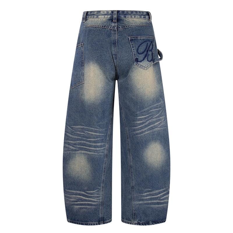 Back view of blue wide-leg jeans with faded wash, back patch pockets, and side loop detail
