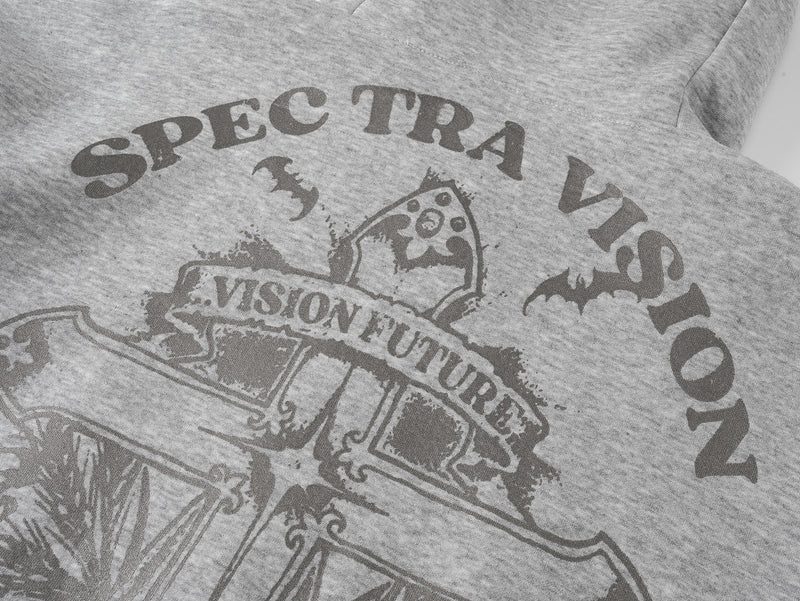 Close-up of gray hoodie back print with SPEC TRA VISION text and crest