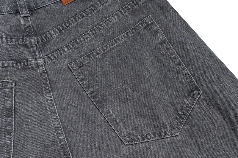Back pocket detail on washed grey denim pants with stitched rectangular pocket