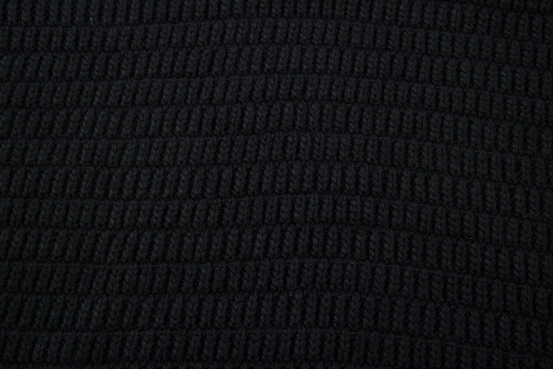 Close-up of black textured knit fabric with horizontal ribbed pattern