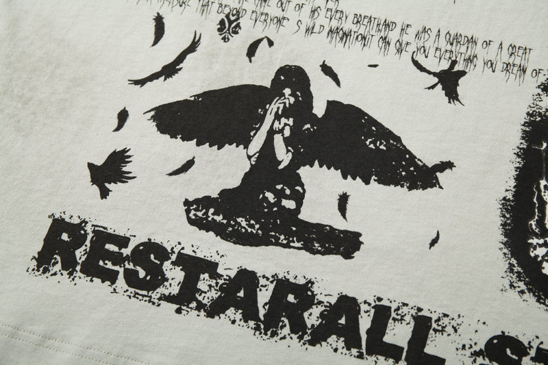 Distressed cream raglan tee with bold black gothic wings, birds, and worn underground graphic print