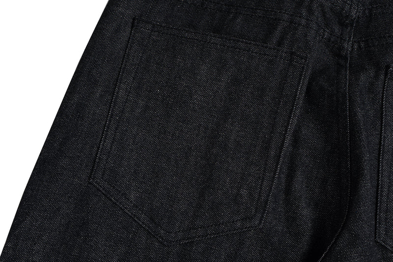 Close-up of the back pocket on black denim jeans