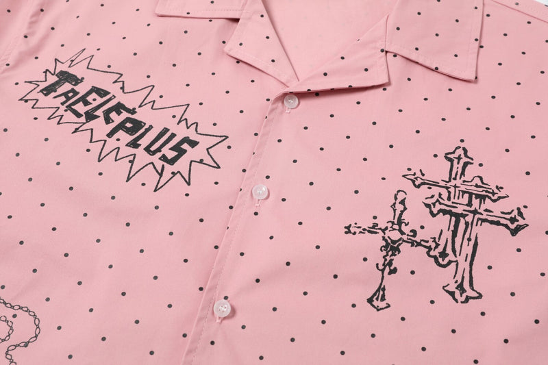 Close-up of pink shirt front with buttons and cross graphic