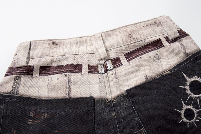 Close-up of printed light waistband on black distressed denim pants with belt loops