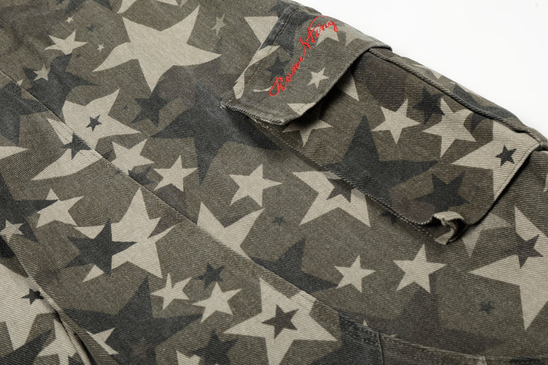 Close-up of cargo pocket flap with red script embroidery on star camo pants