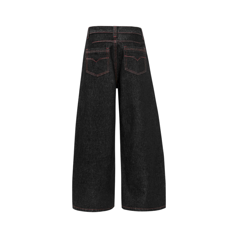Back view of black wide leg denim pants with contrast red stitching and patch pockets