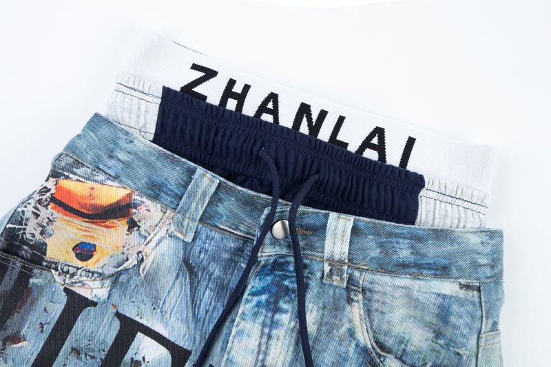 Close-up of layered elastic waistband on blue graphic denim pants with drawstring