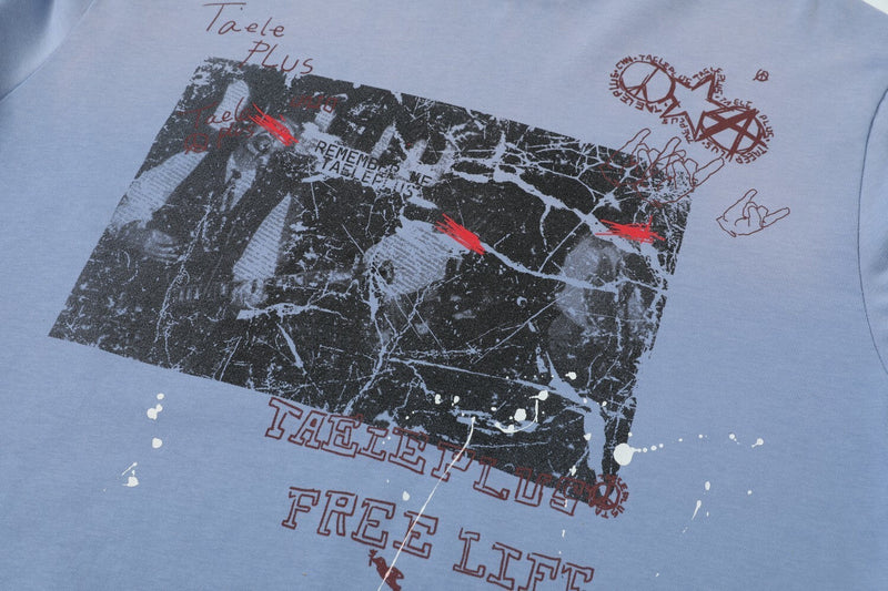 Close-up of the front graphic on a light blue long-sleeve T-shirt with distressed print details