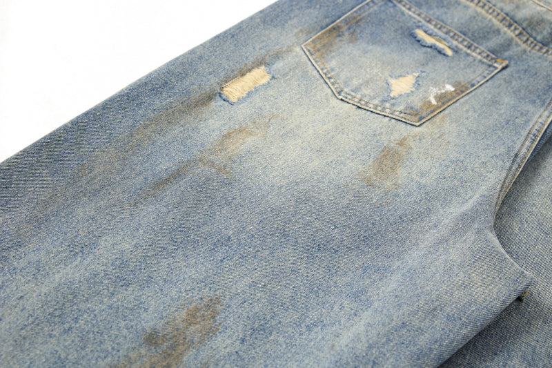 Close-up of back pocket and faded wash on blue denim pants