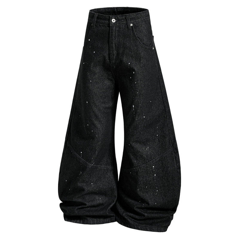 Black wide-leg jeans with paint splatter and curved side seams, front view