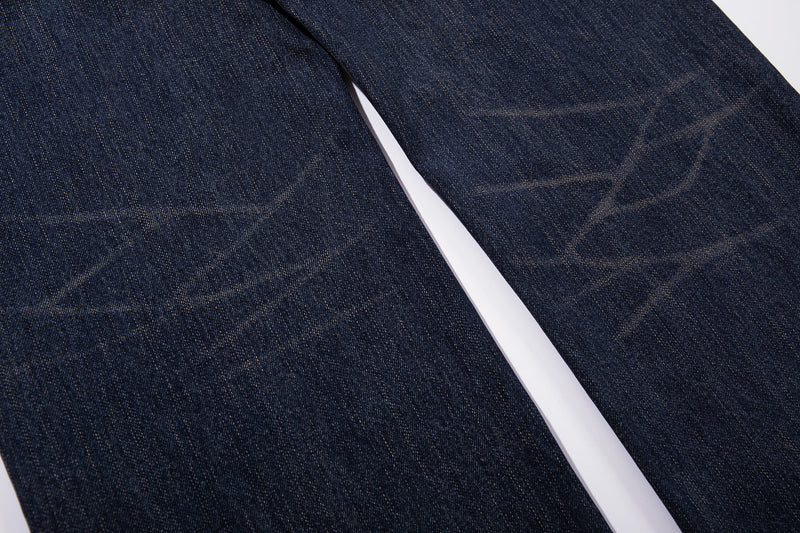 Close-up of the wide-leg denim legs in dark wash with faded whiskering