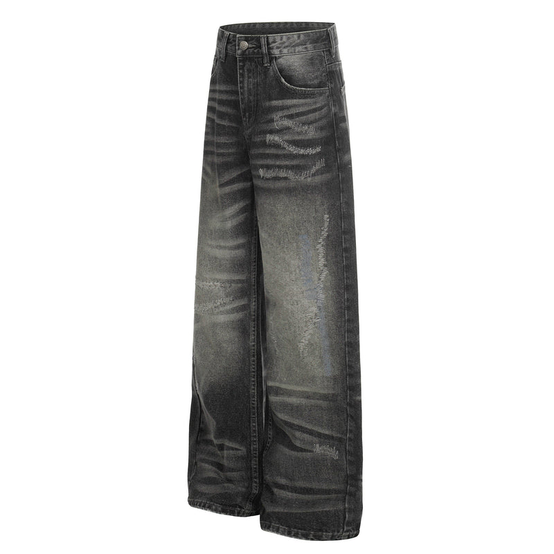 Front three-quarter view of black distressed wide-leg denim pants with fading and whiskering