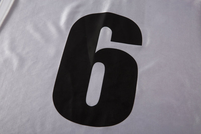 Close-up of white jersey back number 6 on smooth satin fabric