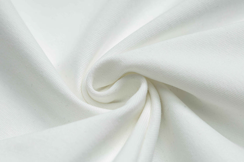 White fabric close-up with a soft twisted texture, showing the material used for a vintage crest graphic T-shirt