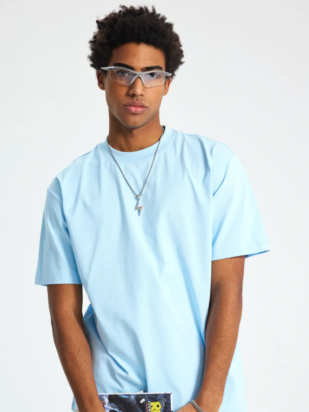 A person wearing the Custom Anime Character Sky Blue T-Shirt - Personalized 230GSM 100% Cotton Tee, along with clear protective glasses and a silver necklace, stands against a plain white background.