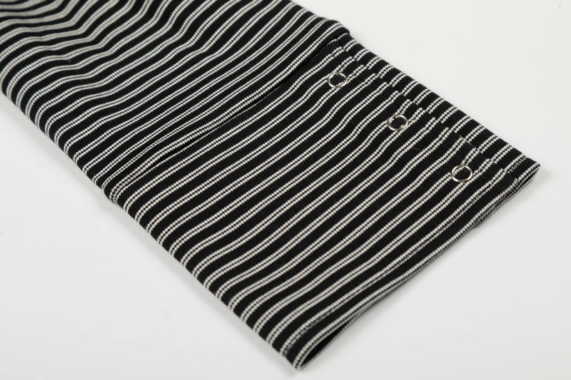 Close-up of sleeve cuff with metal eyelets on black striped hoodie