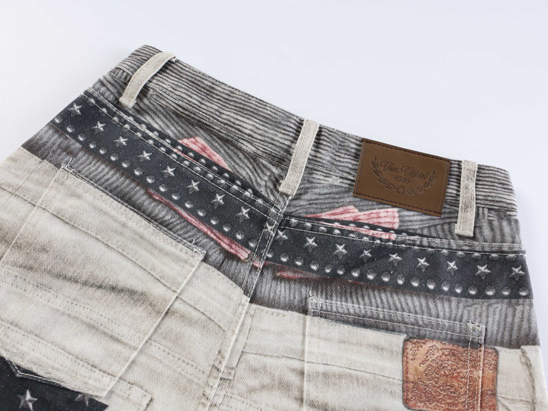 Close-up of waistband with brown logo patch, belt loops, and printed denim trim