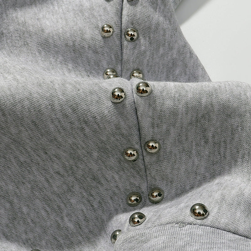 Gray zip hoodie close-up of sleeve seam and ribbed cuff with metal studs
