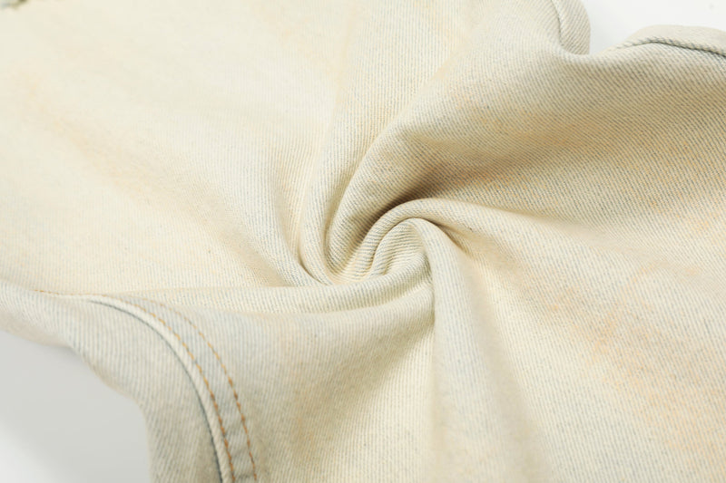 Close-up of cream denim fabric texture and seam stitching