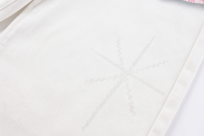 Close-up of smooth white denim leg with faint seam detail