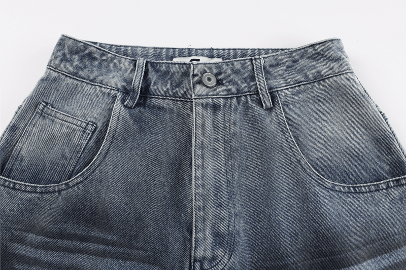 Close-up of the front waistband with button closure and belt loops