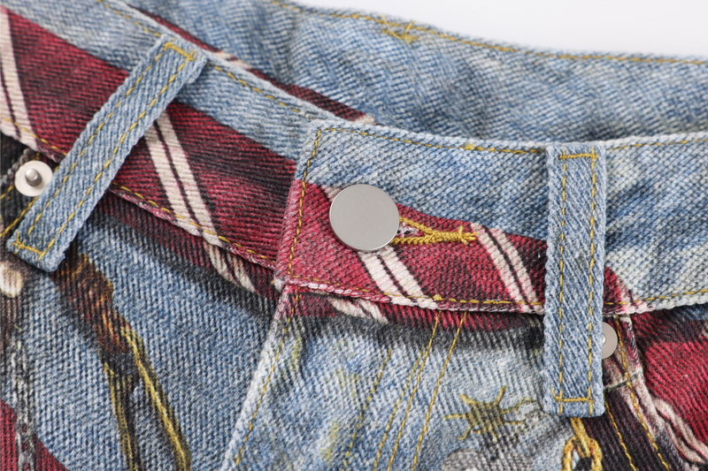 Close-up of red striped tie belt with silver snap button and denim belt loops