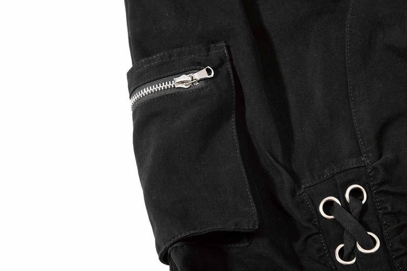 Black shorts zipper pocket and lace-up hem detail, close-up