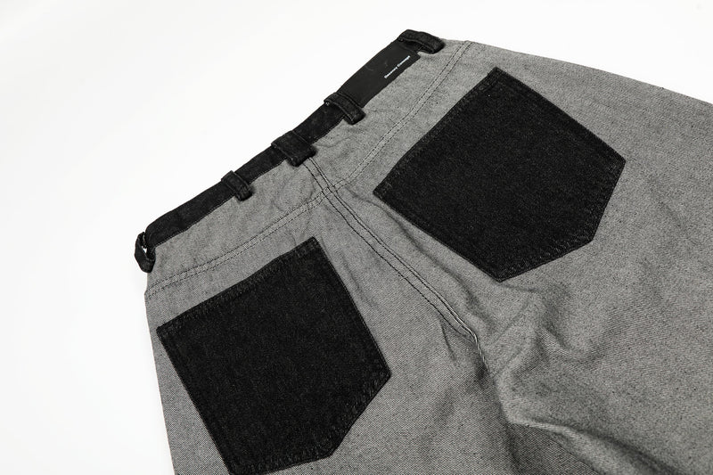 Close-up of back waist and black patch pockets on gray wide-leg jeans