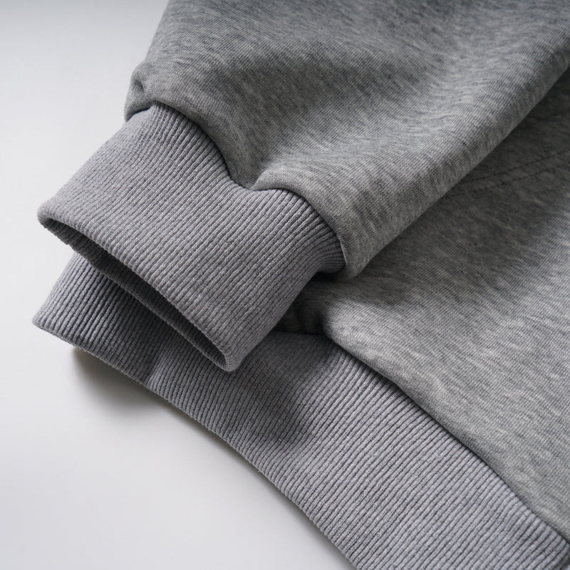 Close-up of ribbed gray sleeve cuff on the zip-up hoodie