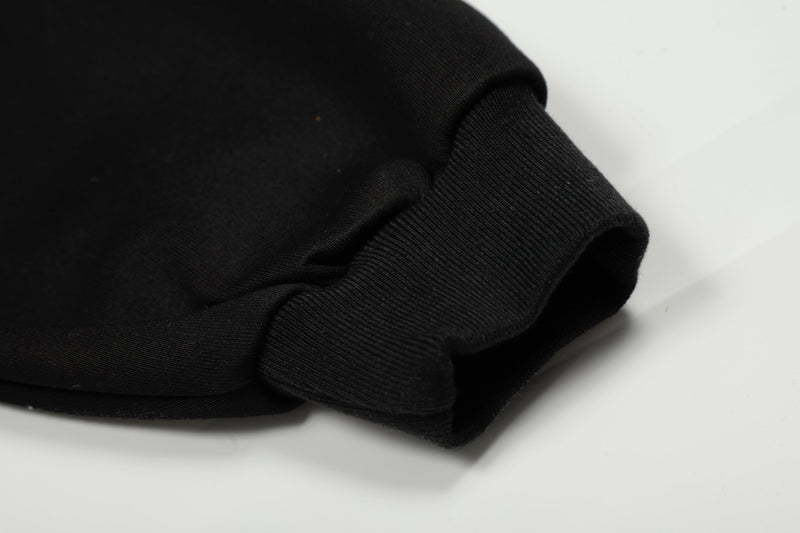 Close-up of black ribbed cuff and sleeve hem on a sweatshirt