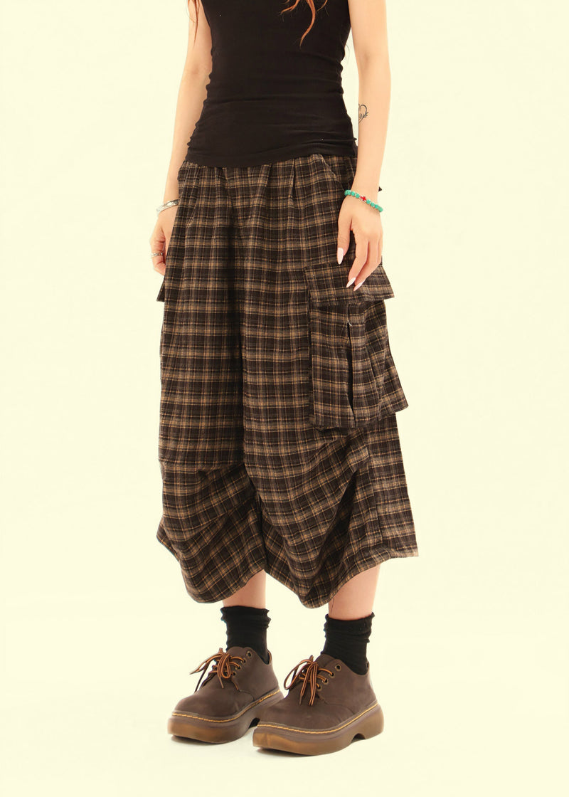 Model wearing plaid cargo shorts with wide cropped legs and brown shoes