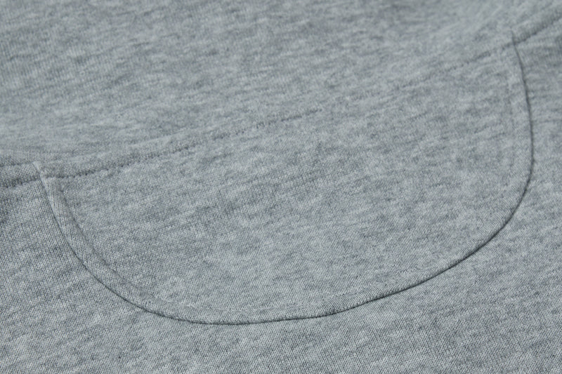 Close-up of curved back seam on gray hoodie fabric