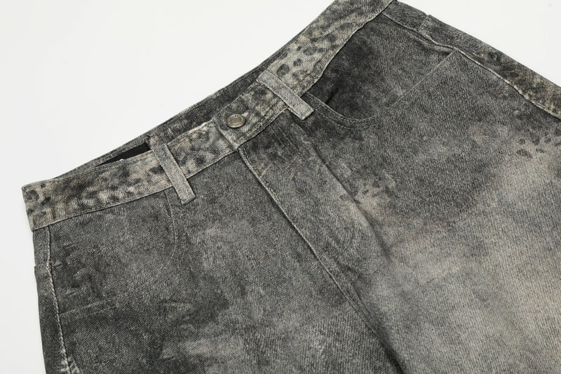 Close-up of waistband and front pocket on gray washed denim pants