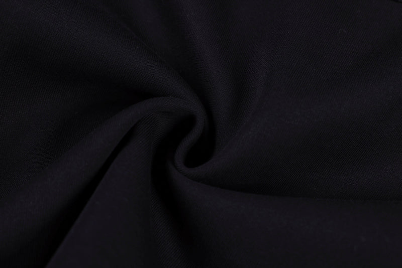 Black fabric close-up with soft drape and fine ribbed texture
