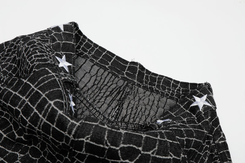 Close-up of black pants interior waistband with white star details