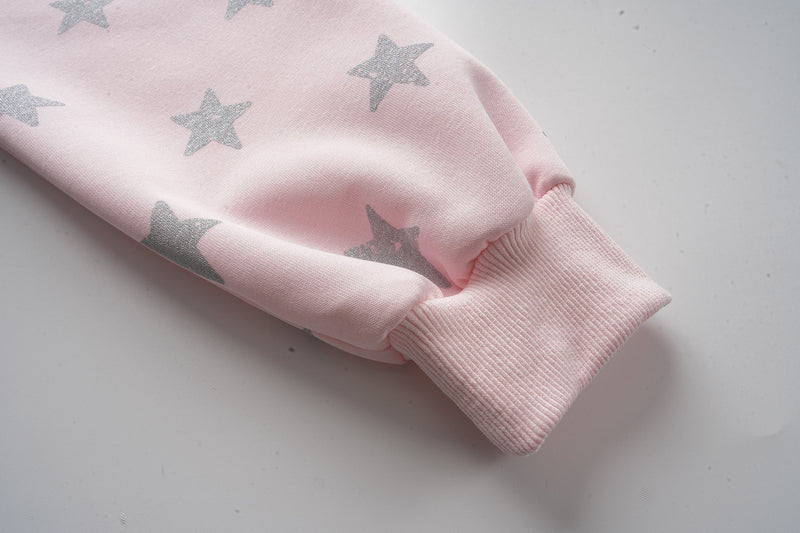 Pink hoodie sleeve cuff close-up with silver star pattern