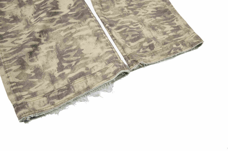 Frayed hem close-up on beige camouflage cargo pants