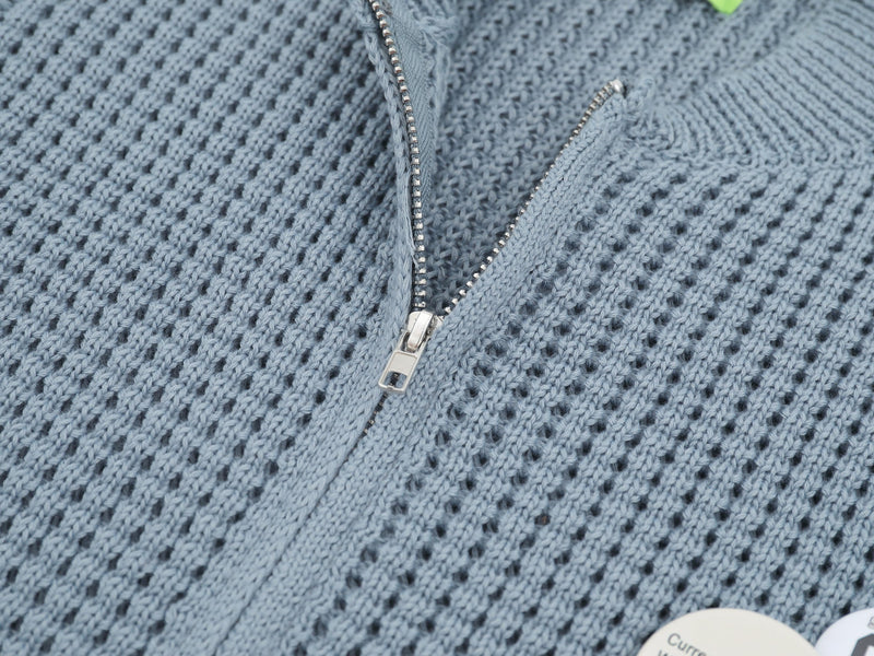 Close-up of light blue cardigan zipper and waffle knit texture