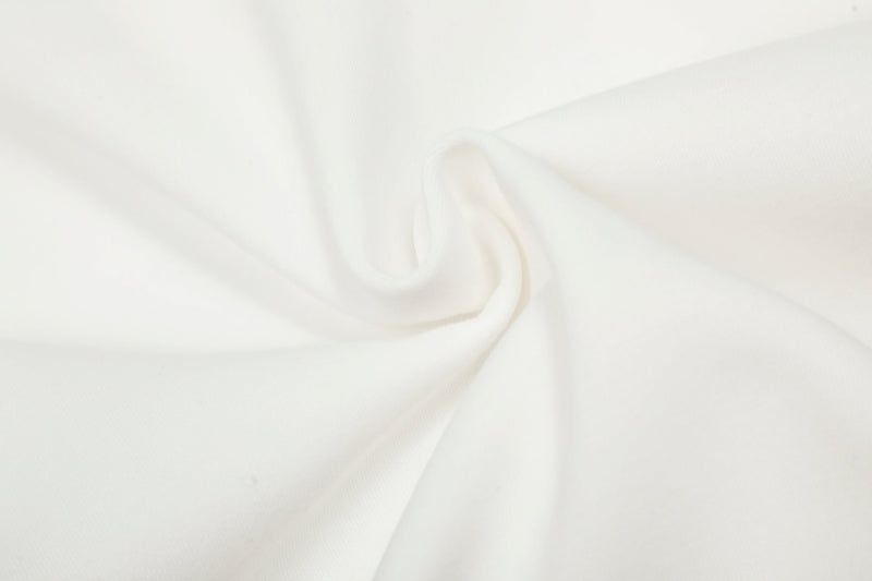 Close-up of white hoodie fabric with soft gathered fold detail