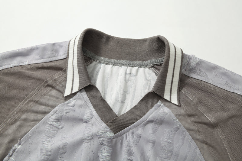 Textured patchwork tee with striped collar and distressed mesh panels in gray and white