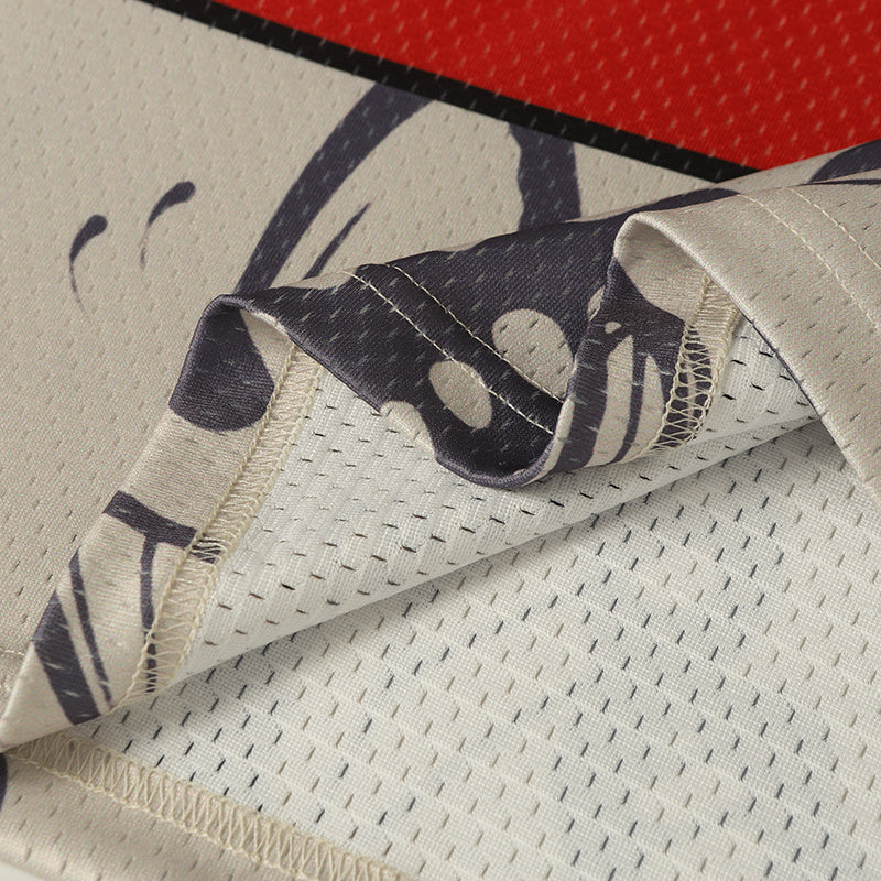 Close-up of butterfly graphic football jersey fabric with breathable mesh and stitched hem, showing cream and black varsity-style details