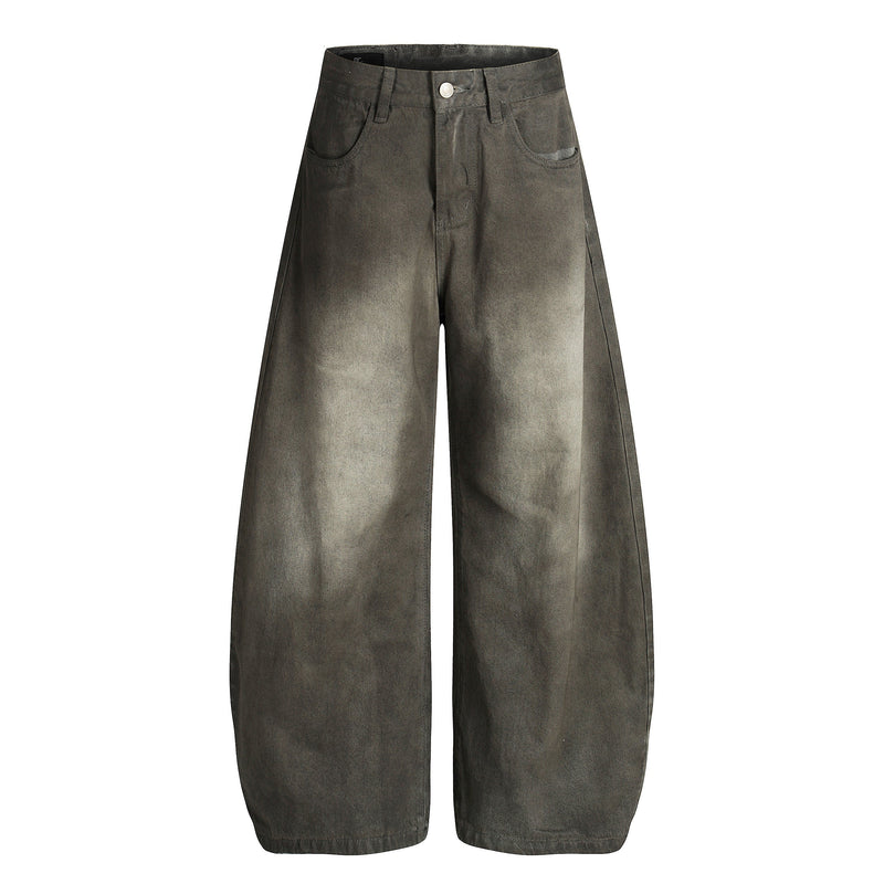 Front view of faded black wide-leg denim pants with curved legs and five-pocket styling