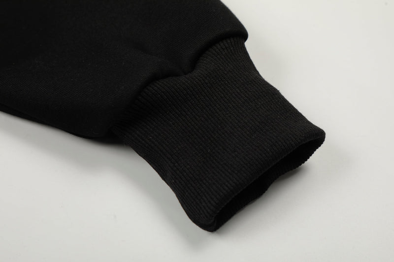 Close-up of black ribbed sleeve cuff on the hoodie
