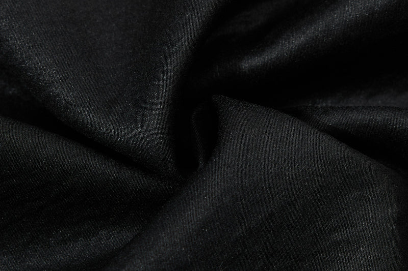 Close-up of black fabric folds showing soft texture and stitching