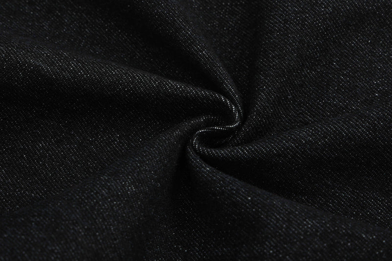 Close-up of black denim fabric folds and texture