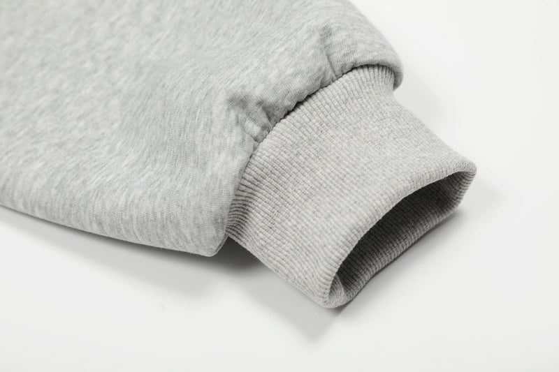Close-up of light gray hoodie cuff with ribbed sleeve hem