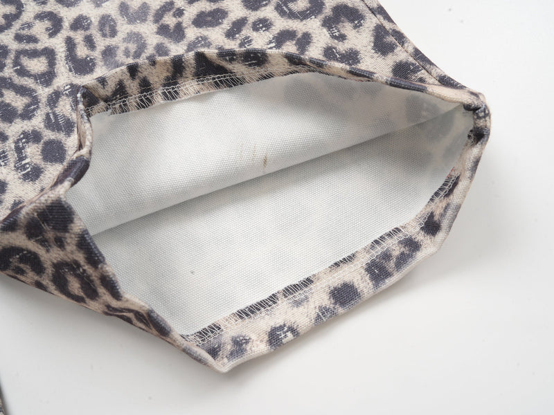 Close-up of pant cuff showing white inner lining and leopard print outer fabric
